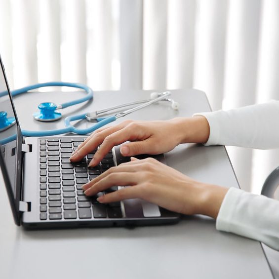 160419946 – healthcare professionals entering data into a personal computer